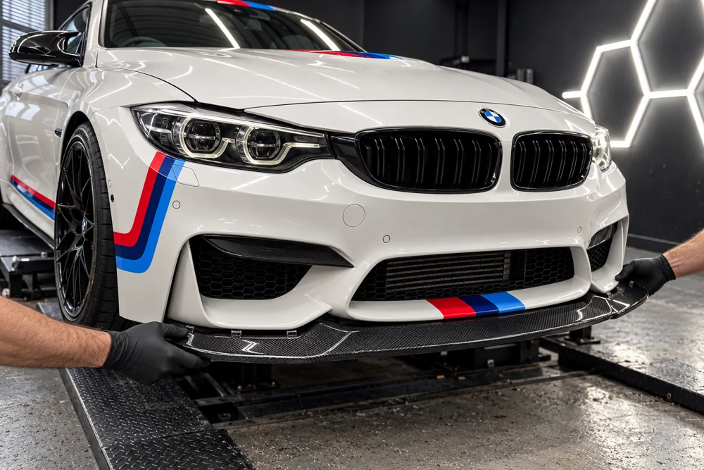 Illustration of a carbon front splitter being aligned on a white BMW M4